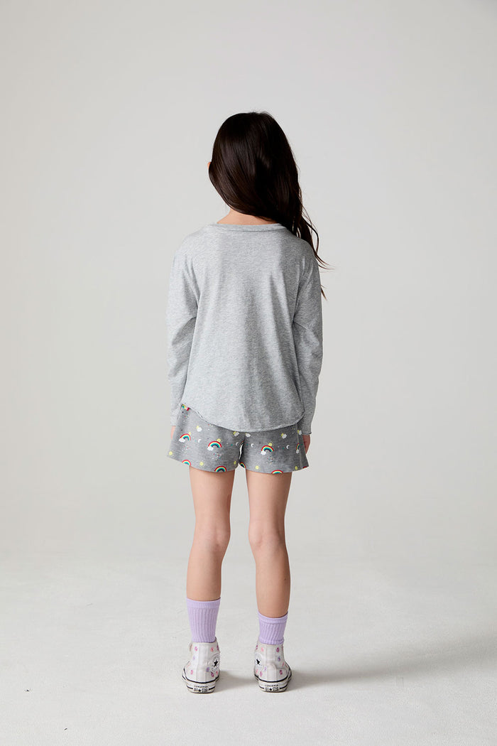 Full body back view of a girl wearing the Chaser Rainbow Morning Long Sleeve on a neutral background