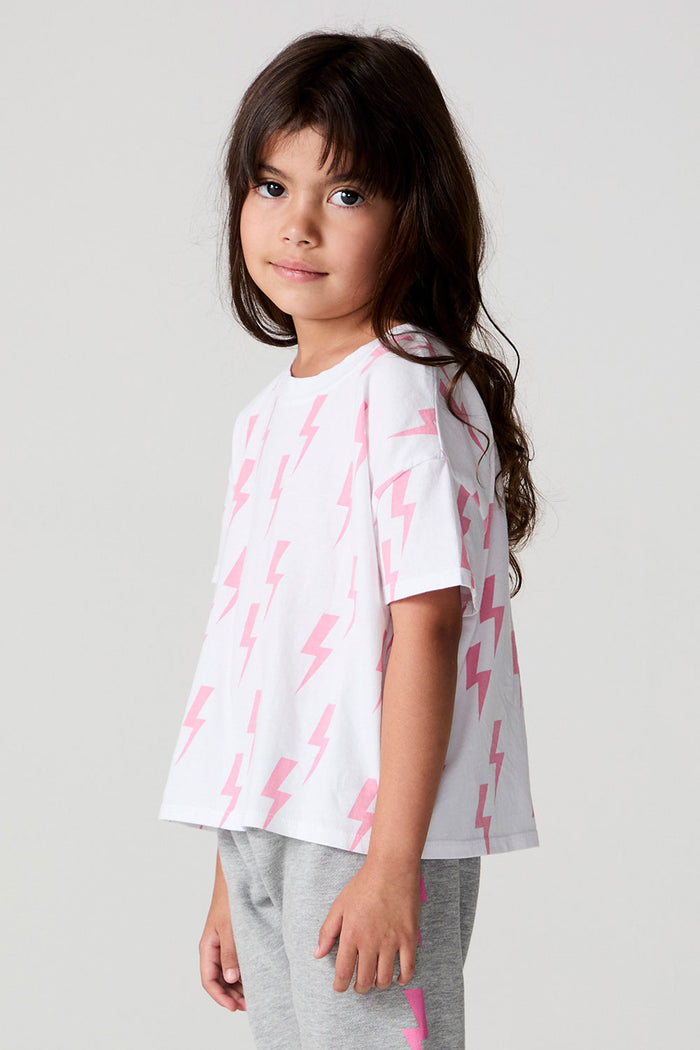 Side angle view of a girl wearing the Chaser Raining Bolts Tee on a neutral background