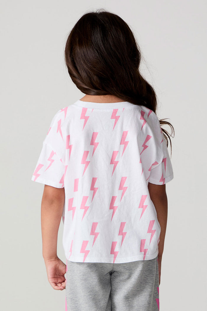 Back view of a girl wearing the Chaser Raining Bolts Tee on a neutral background