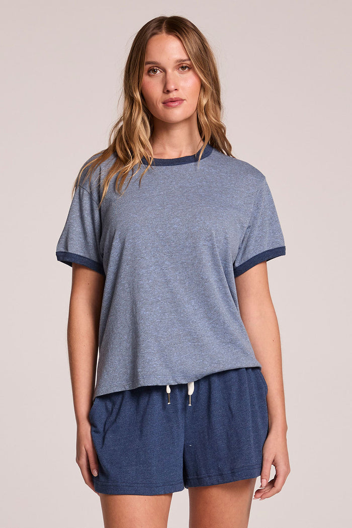 Front view of a woman wearing the Chaser  Rambler Admiral and Serenity Tee and shorts on a neutral background