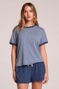 Front view of a woman wearing the Chaser  Rambler Admiral and Serenity Tee and shorts on a neutral background