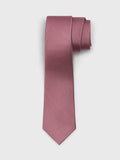 Raspberry pink silk necktie rolled into a coil on light grey background
