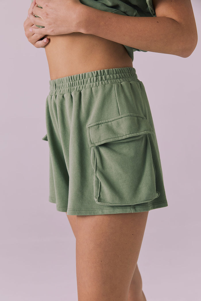 Chaser Rileyy Meadow Green Shorts side close-up showing the pocket flap and smooth fleece finish