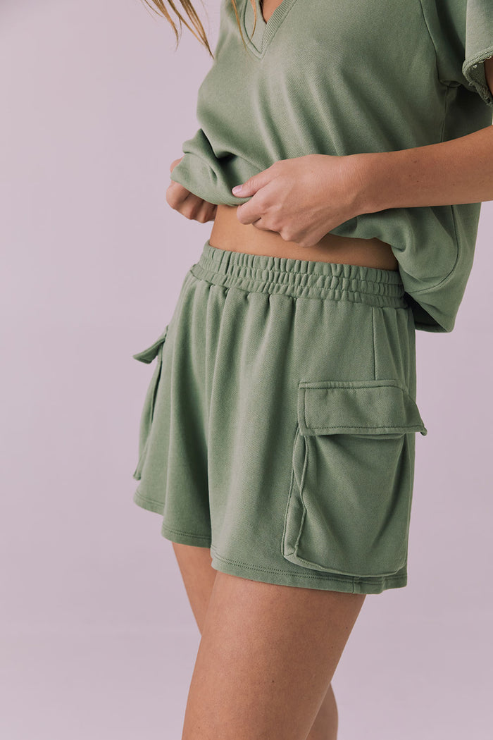 Chaser Rileyy Meadow Green Shorts three quarter side angle highlighting the relaxed drape and pocket structure