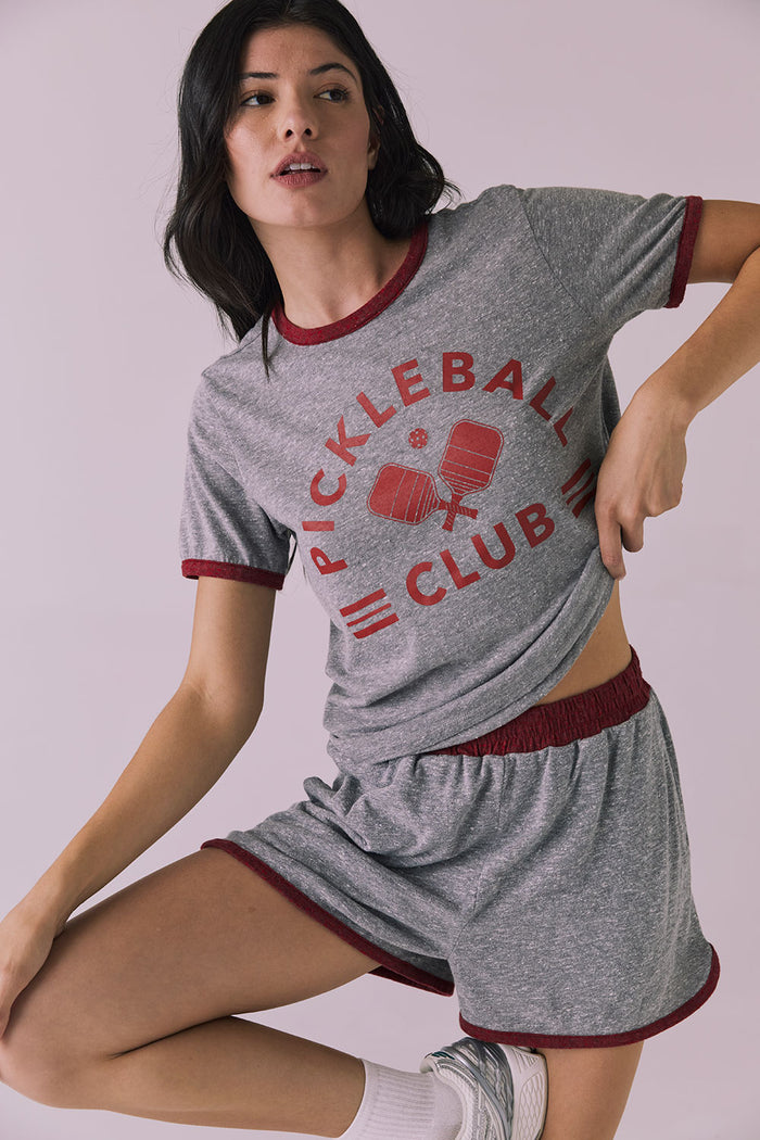 Mid-body angle of the Ringer Shorts in Heather Grey with Crimson trim styled with the Pickleball Club Tee for a sporty set look