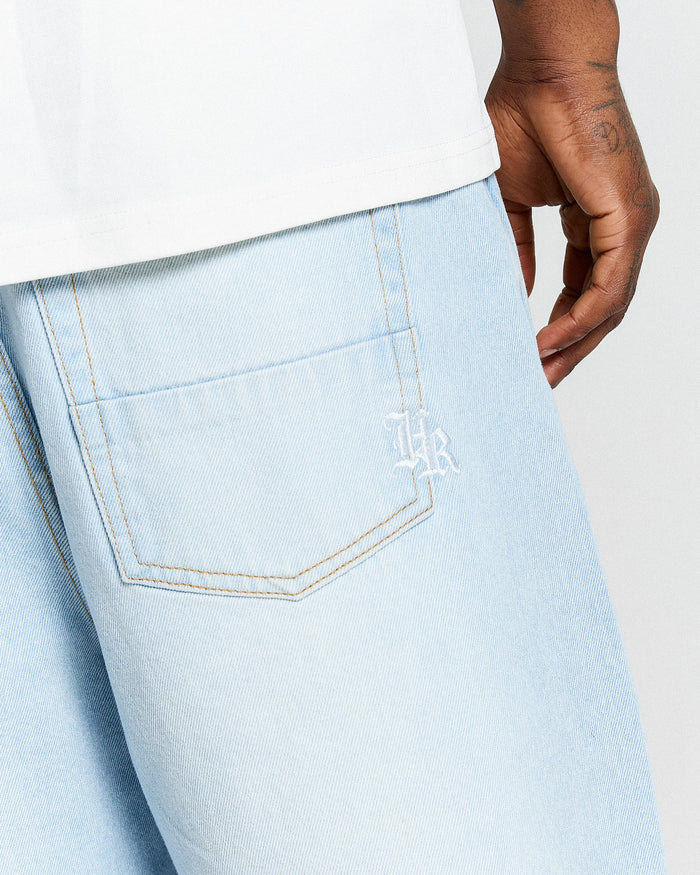 Light blue jeans with a brand logo on the pocket against a white background