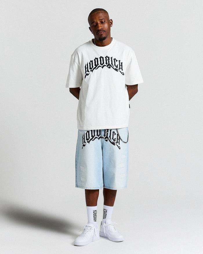 Person wearing a white t-shirt and light blue shorts with 'Hoodrich' branding on a plain background