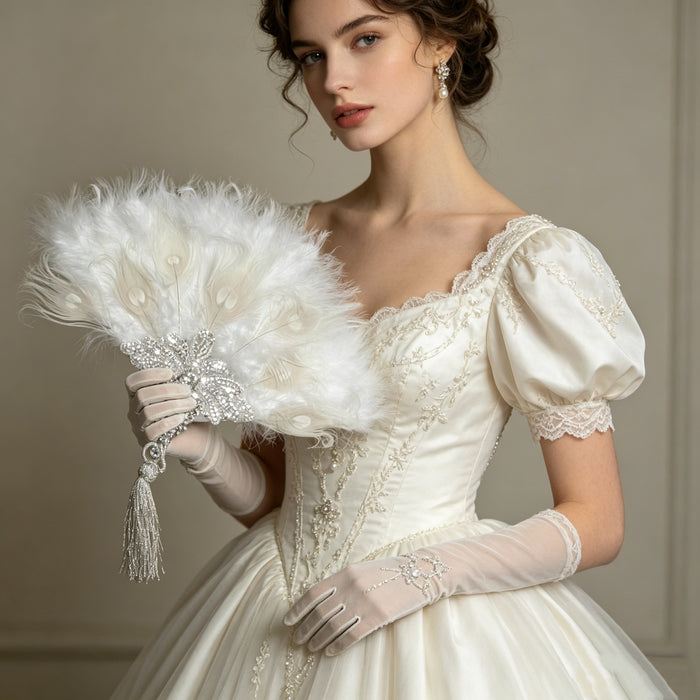 Luxury feather hand fan with pearl embroidery and crystal embellishments styled for a romantic bridal gown and elegant ballroom look.
