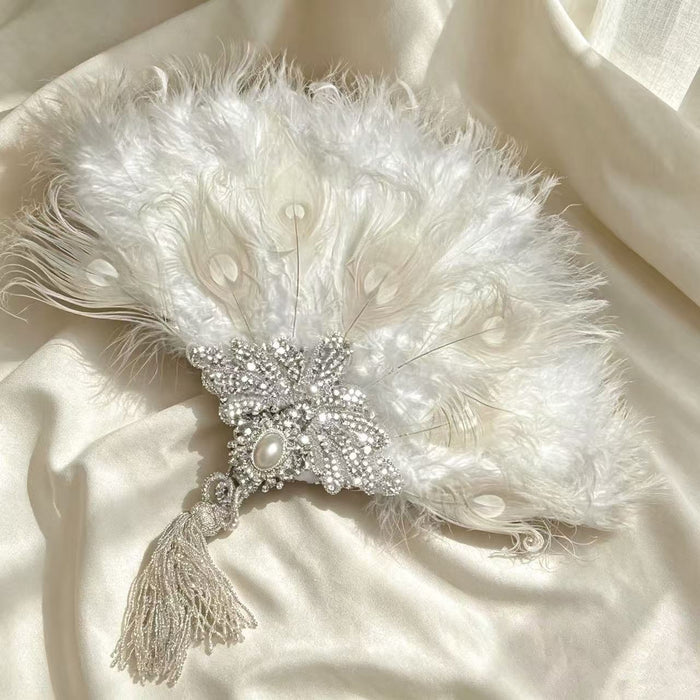 Handcrafted Rococo bridal fan with white feathers, pearl beads, sequins and Victorian inspired details for wedding and vintage events.