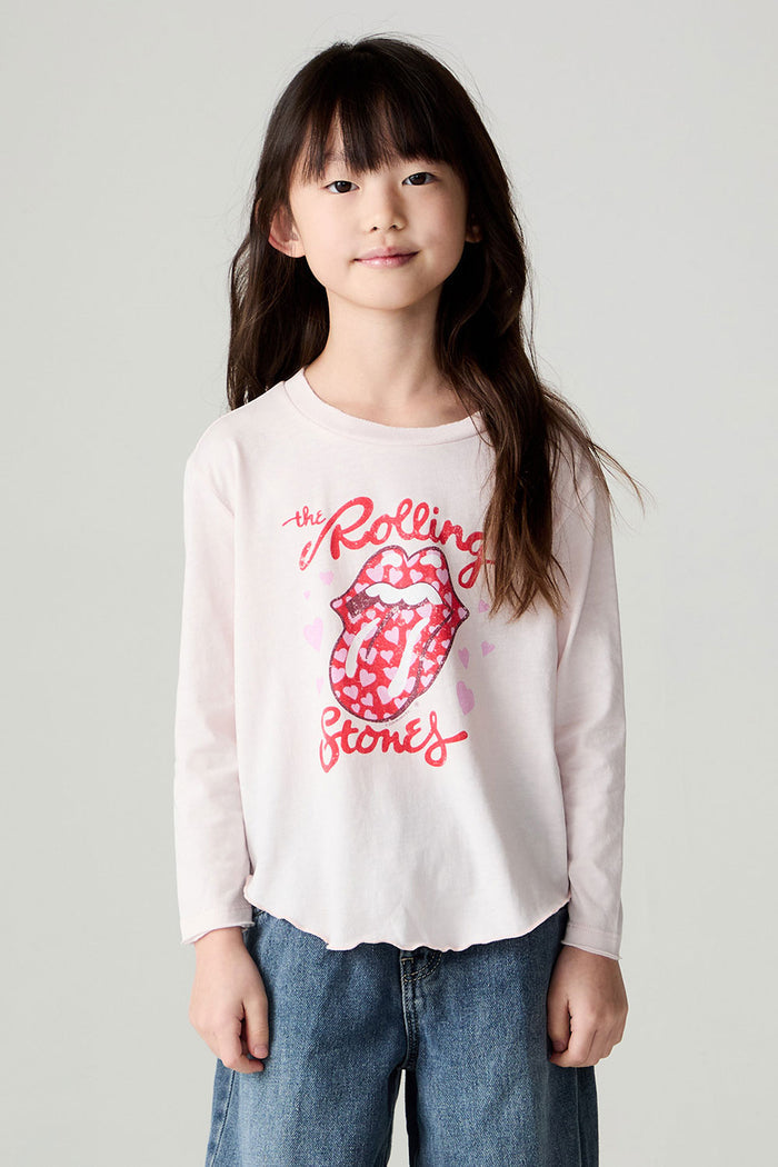 Front view of a girl wearing the Chaser Rolling Stones Luv The Stones Girls Tee on a neutral background with baggy jeans