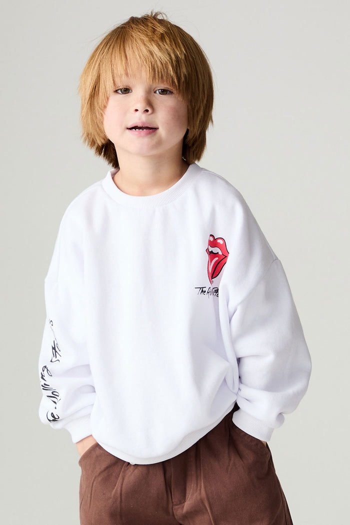 Front view of a boy wearing the Chaser Rolling Stones Pop Tongues Boys Tee on a neutral background with hands in pockets