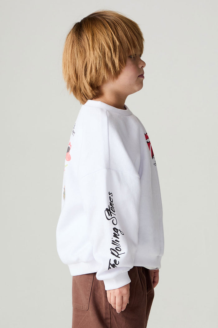 Side view of a boy wearing the Chaser Rolling Stones Pop Tongues Boys Tee on a neutral background with arms at sides