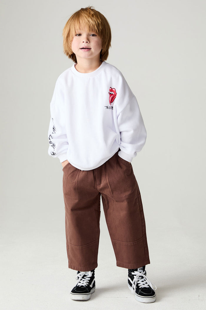 A full body front view of a boy wearing the Chaser Rolling Stones Pop Tongues Boys Tee on a neutral background