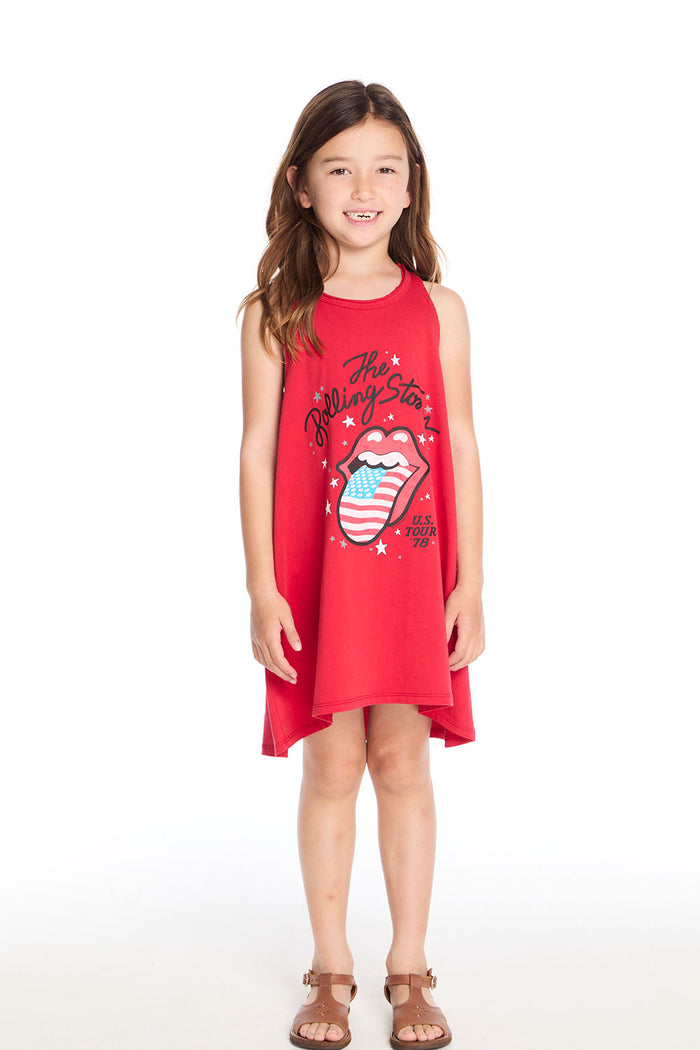 Girl wearing the Chaser Kids Rolling Stones U.S. Tour ’78 Tank Dress styled with tan sandals, posing against a white background