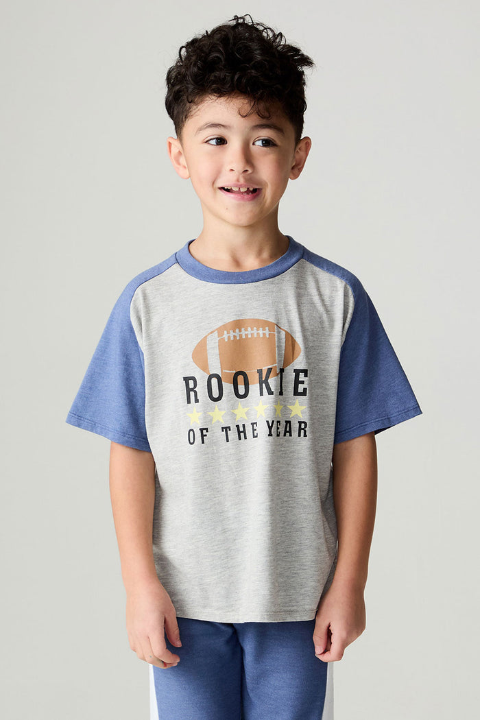 Front view of a boy wearing the Chaser Rookie Boys Tee on a neutral background with arms at sides and matching blue pants