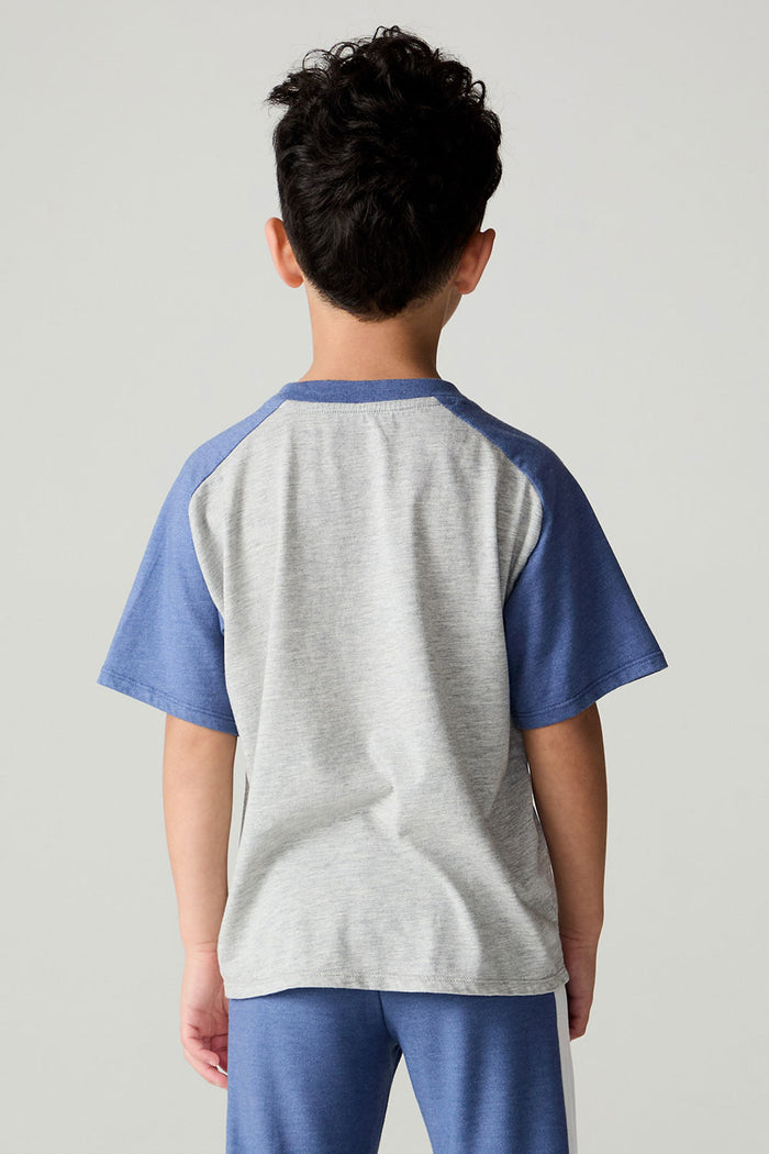 Back view of a boy wearing the Chaser Rookie Boys Tee on a neutral background with arms at sides and pants