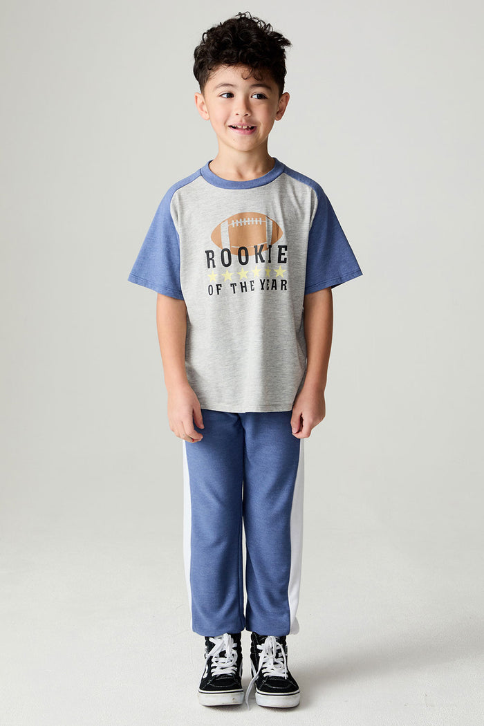 A full body front view of a boy wearing the Chaser Rookie Boys Tee on a neutral background with arms at sides