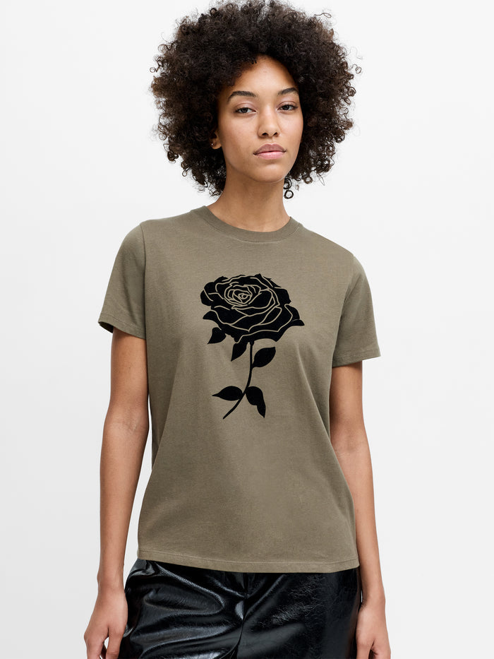 A woman wearing a khaki T-Shirt with a black rose graphic, short sleeves, a crew neckline and a regular fit.