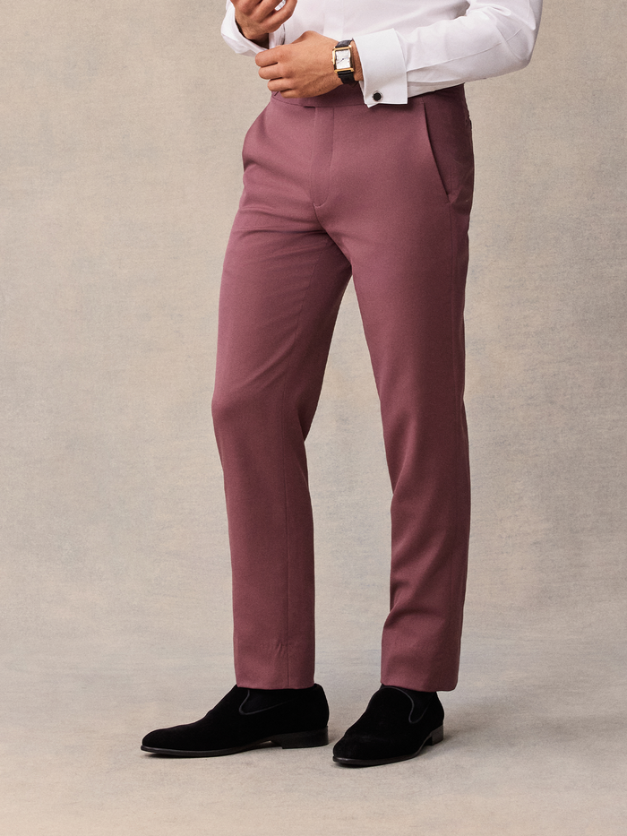 Close-up of man in dusty rose tuxedo trousers, front view, white shirt visible