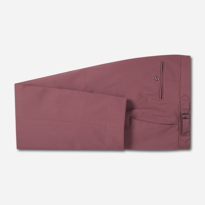 Dusty rose tuxedo trousers folded flat, side view, on light grey background