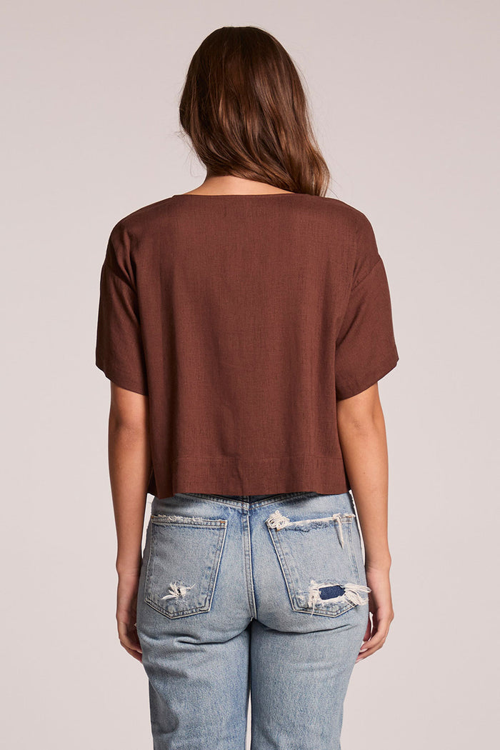 Back view of a woman wearing the Chaser  Roselie Kahlua Blouse on a neutral background