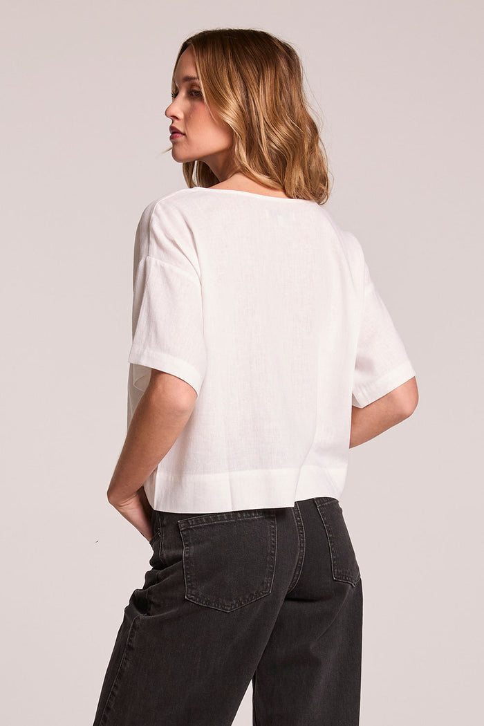 Back view of a woman wearing the Chaser Roselie White Blouse on a neutral background