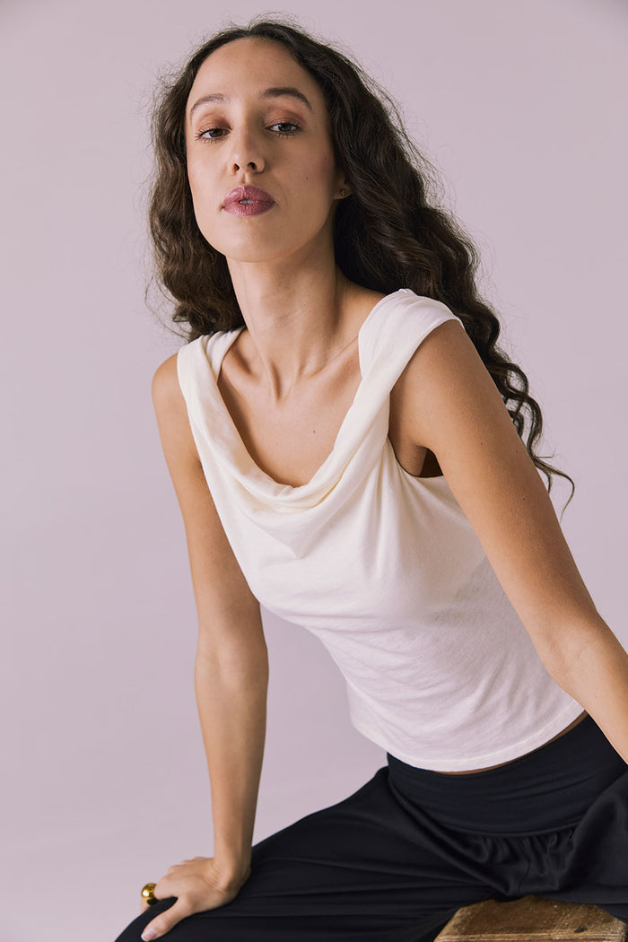 Chaser Roxanne Starry White Tank shown in a seated three quarter view with subtle draping across the chest