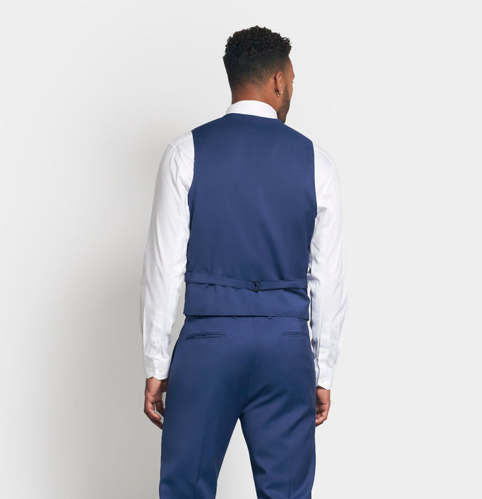 Back view of man in royal blue suit vest and trousers