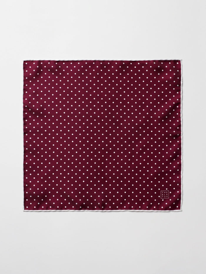 Ruby silk pocket square with white polka dots, laid flat and unfolded.