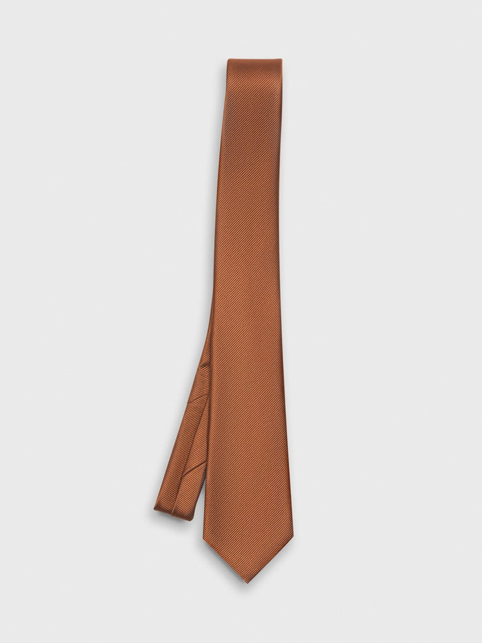 Rust silk necktie draped with a diagonal weave on a white background