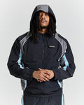 Person wearing a black and gray jacket with a hood on a light gray background