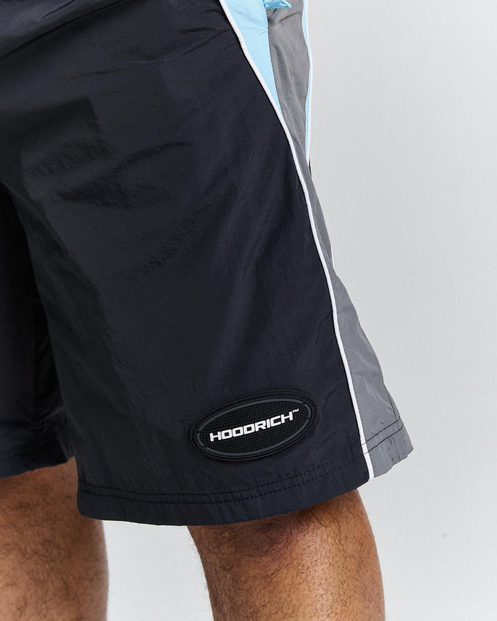 Black shorts with a visible brand logo on a grey background