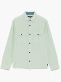 A man wearing a sage green over shirt with long sleeves. a pointed collar and a button down fastening.