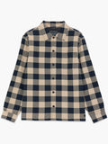 A man wearing a sandy navy check Over-shirt with long sleeves, a pointed collar, a button down fastening, a chest patch pocket and a regular fit.