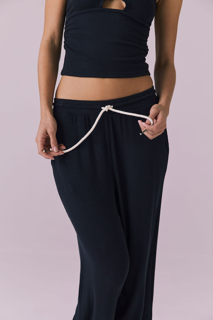 Close up of Chaser Sandyy Licorice Black Trouser waistband showing rib knit texture and contrast rope style drawcord
