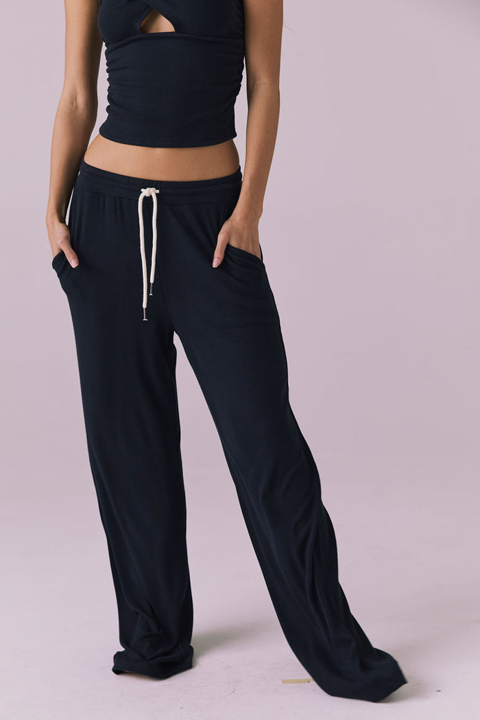 Chaser Sandyy Licorice Black Trouser front view from waist down showing long wide leg hem pooling slightly at the floor