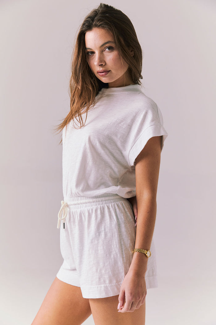 Cropped side portrait view of the Chaser Sanremo White Romper highlighting the relaxed neckline and waist shape