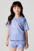 Front view of a girl wearing the Chaser Seashell Dreams Tee and shorts on a neutral background