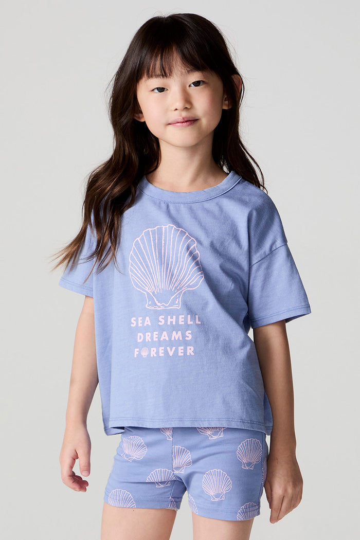 Front view of a girl wearing the Chaser Seashell Dreams Tee and shorts on a neutral background