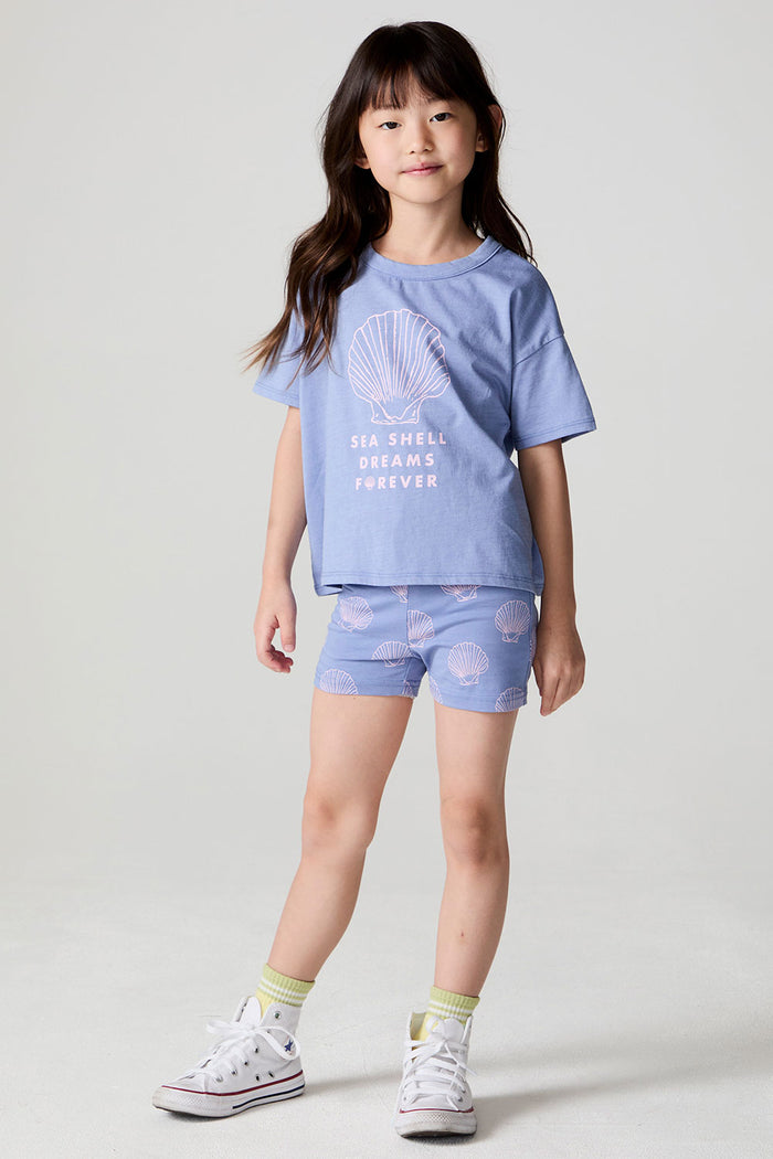 Full body front view of a girl wearing the Chaser Seashell Dreams Tee and matching shorts on a neutral background