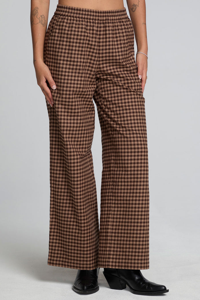 Front view of a woman wearing the Chaser Seren Choco Check Pants on a neutral background
