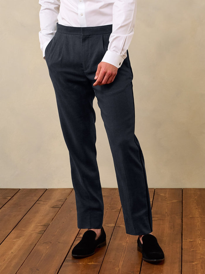Shadow black linen tuxedo pants on model in white shirt, front waist-down view, hand in pocket