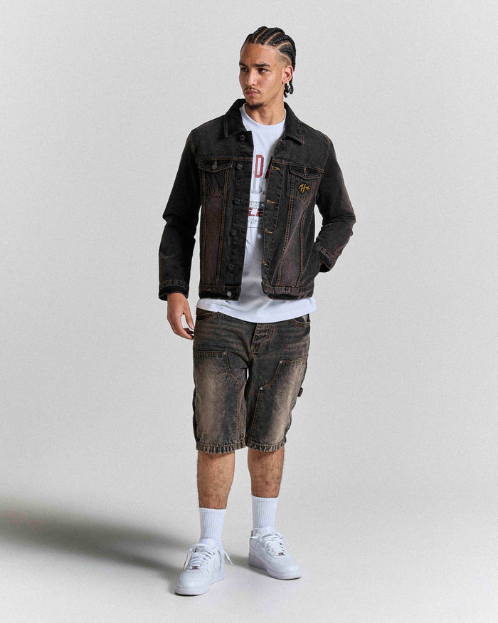 Model wearing regular fit black rust washed denim jorts and a matching jacket.