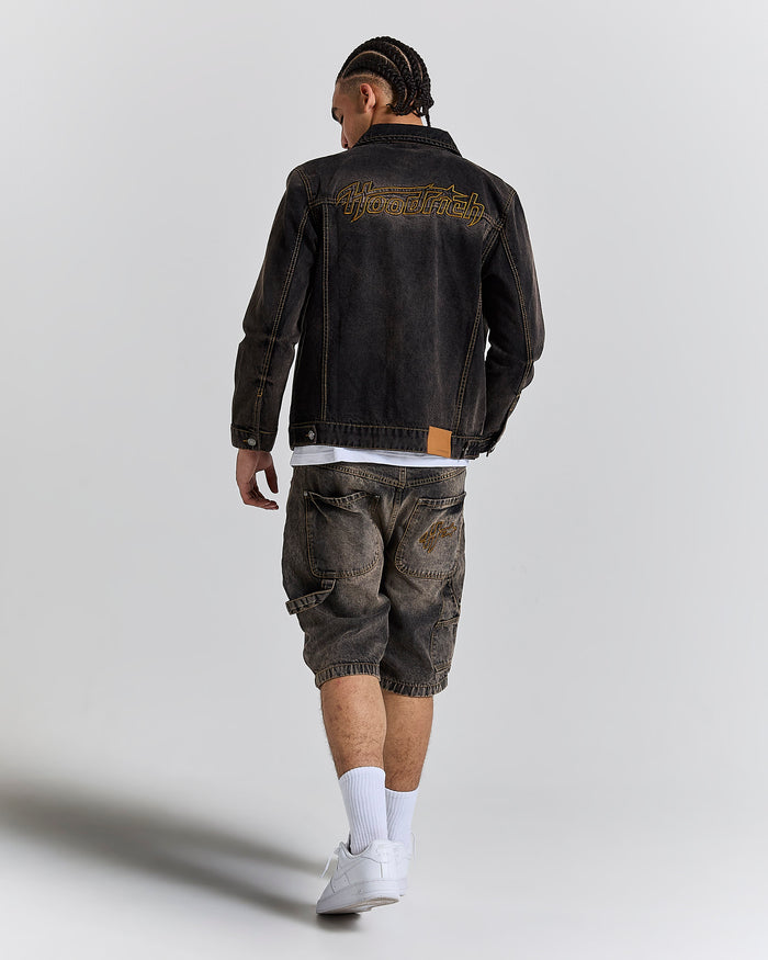 Model seen from behind wearing a regular fit black rust washed denim jacket and matching jeans.