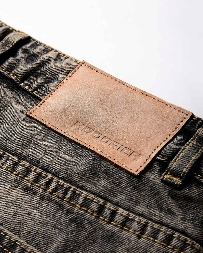 Close-up of a denim fabric with a leather label on a white background