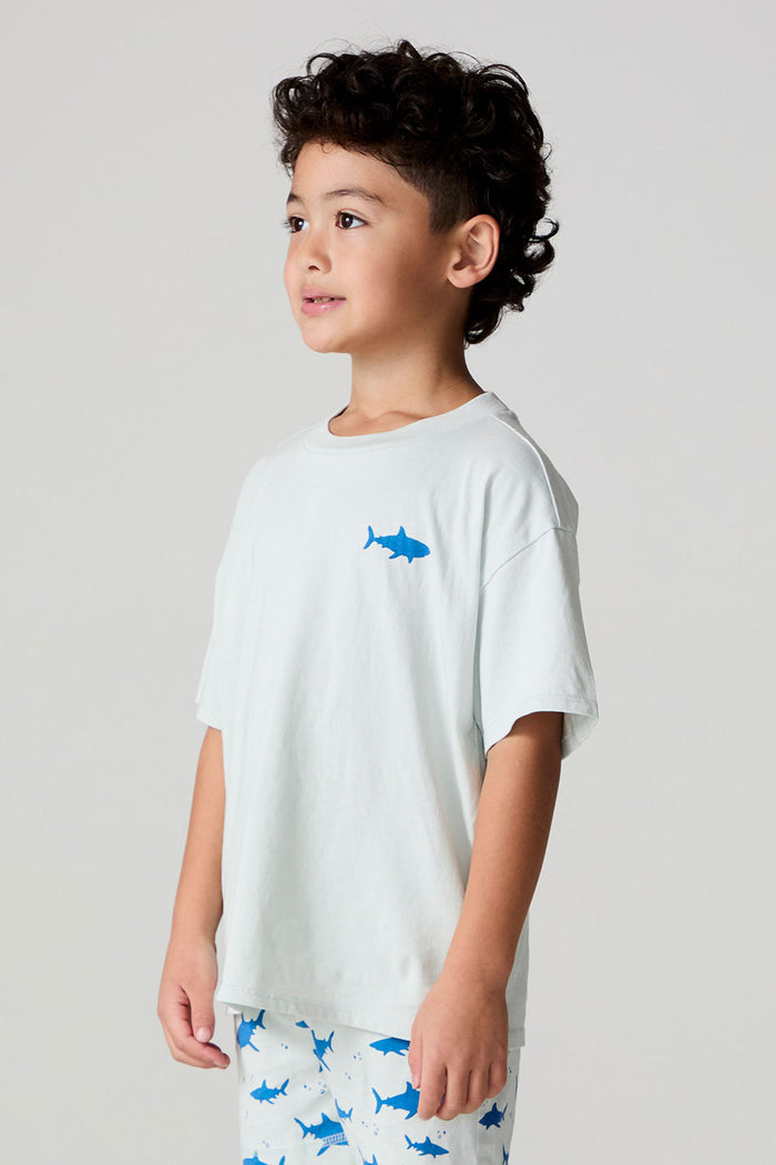 Side angle view of a boy wearing the Chaser  Shark Around Tee on a neutral background