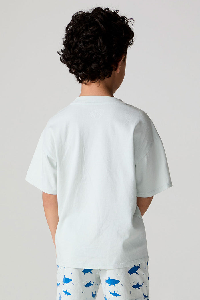Back view of a boy wearing the Chaser  Shark Around Tee on a neutral background