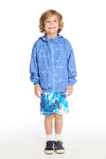 Full body view of boy wearing the Chaser Kids Shark Check Zip Up Hoodie and Shark Bite Shorts styled with white crew socks and navy sneakers on a white background