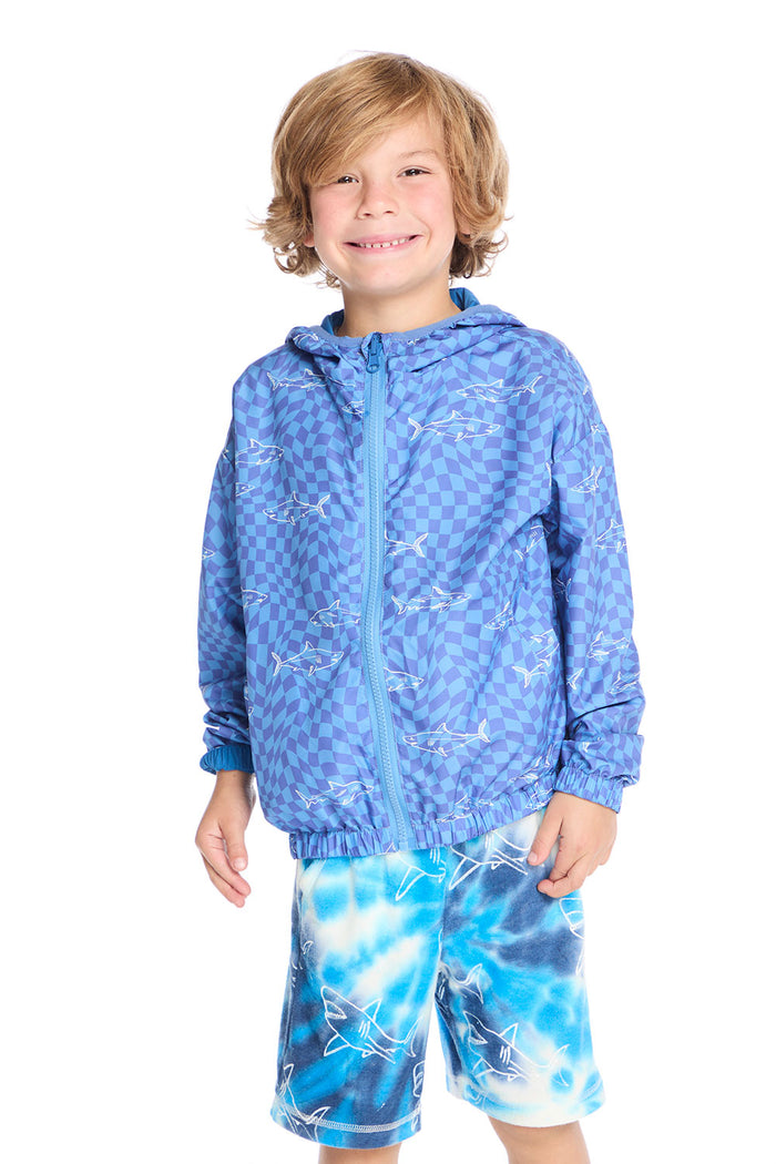 Front view of boy wearing the Chaser Kids Shark Check Zip Up Hoodie in blue checkerboard print with white shark outlines, paired with Shark Bite Shorts on a white background