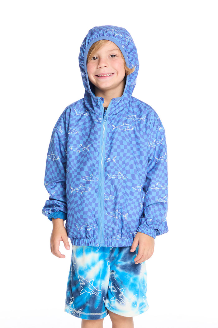 Front view of boy wearing the Chaser Kids Shark Check Zip Up Hoodie with hood up, featuring blue checkerboard shark print, paired with Shark Bite Shorts on a white background